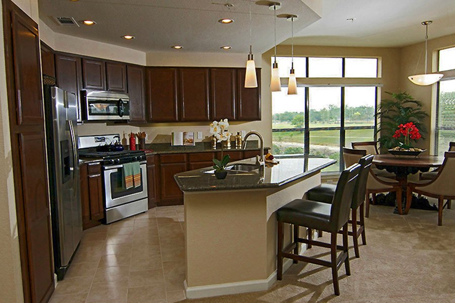 a large kitchen with a bar and a table