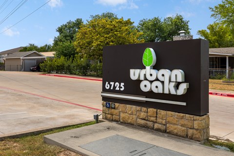 A sign for a place called "Urban Oaks" with a phone number on it.