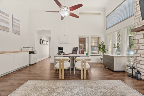 A modern kitchen with a dining table and chairs in the middle.