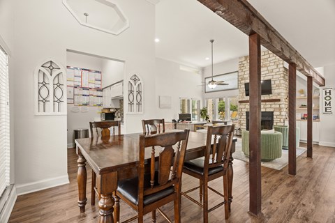 A dining room with a wooden table and chairs.