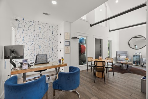 A modern living room with a blue chair and a wooden table.