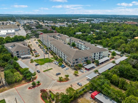 A large building complex with a parking lot in front.