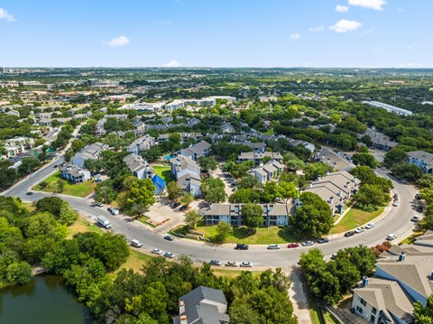 A bird's eye view of a residential area with houses and a roundabout.