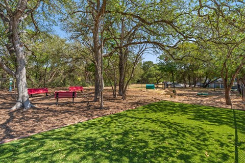 A park with a green lawn and trees.