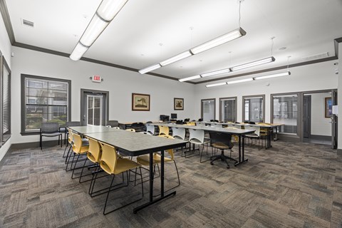A conference room with a long table and chairs.