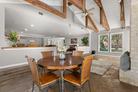 A dining room with a wooden table and chairs.