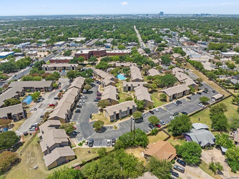 A bird's eye view of a residential area with houses and cars.