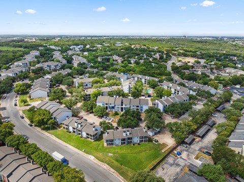 A bird's eye view of a residential area with houses and roads.
