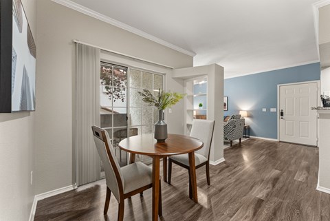 A dining room with a table and chairs.