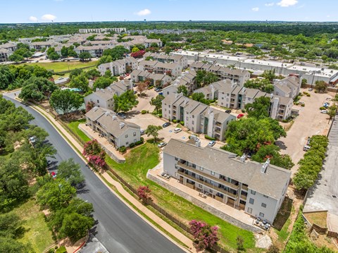 A bird's eye view of a residential area with houses and a street.