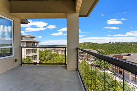 A balcony with a view of a residential area.