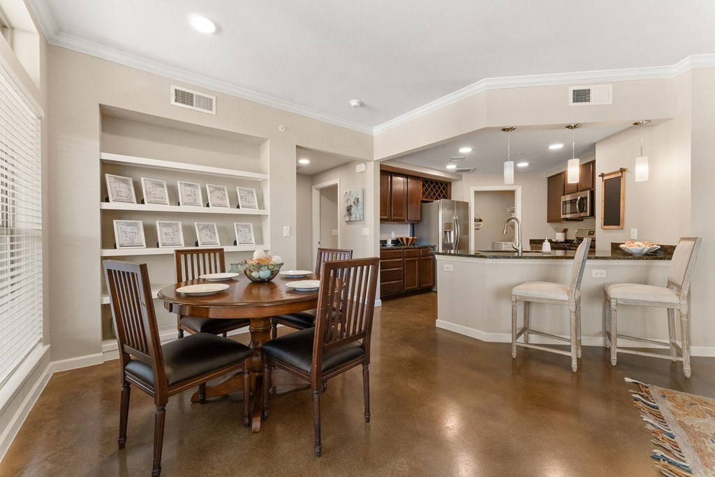 A dining room with a table set for four. at Bridge at Heritage Woods, Austin, 78753