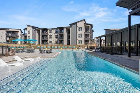 A large swimming pool in front of apartment buildings. at Bridge at Tech Crossing, Texas