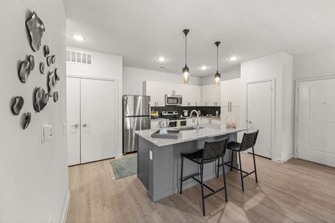 A kitchen with a white counter and a sink.