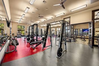 A gym with a variety of equipment including weights and machines. at The Royce at 8100, Austin, TX, 78729