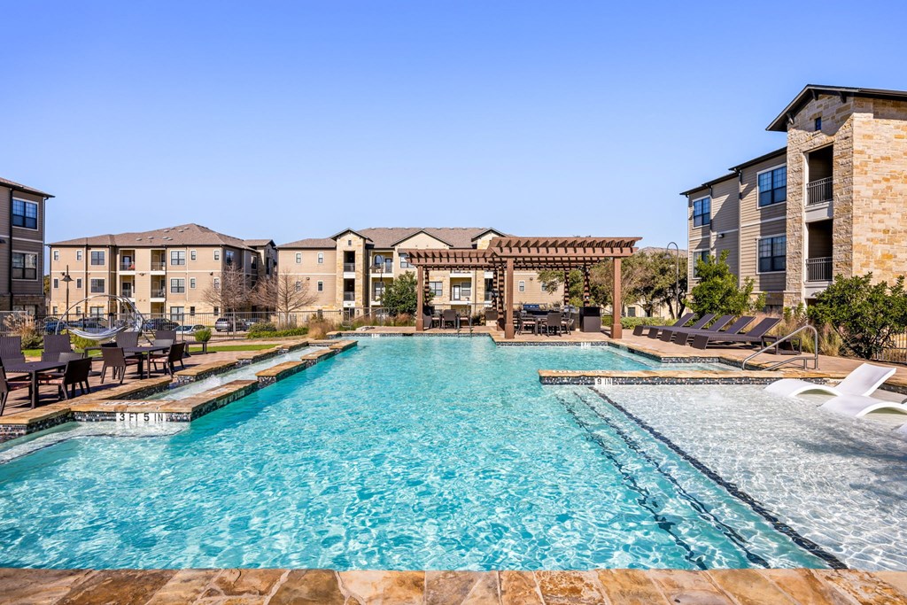 A large swimming pool in front of a resort. A large at The Royce at 8100, Texas, 78729