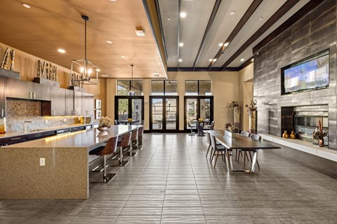 A modern kitchen with a dining table and chairs.