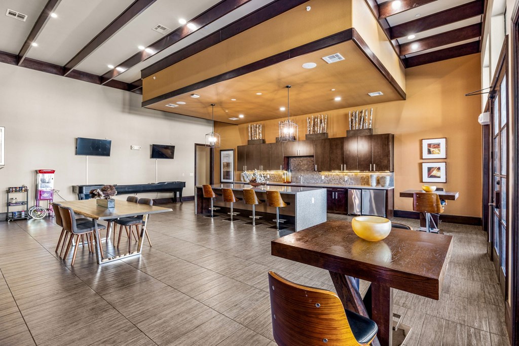 A modern dining room with a wooden table and chairs. A modern dining room with a wooden table and chairs. at The Royce at 8100, Texas