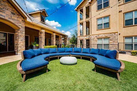 a living area with a blue couch in front of an apartment building