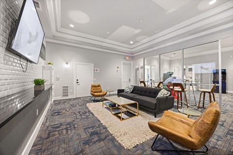 A modern living room with a grey carpet and a wooden chair.