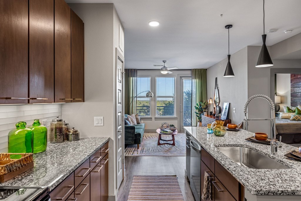 A kitchen with a large island and a window overlooking the living room. at Bridge at Henley, Austin, Texas