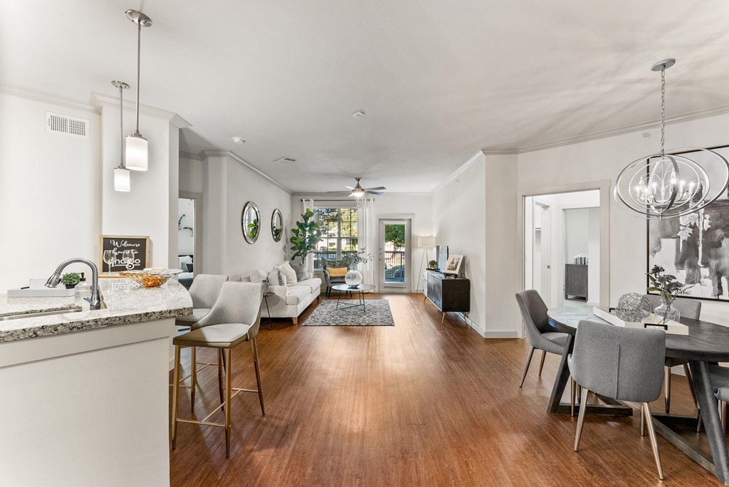 A modern kitchen with a dining area and a living room. at Bridge at Indigo, Austin, Texas