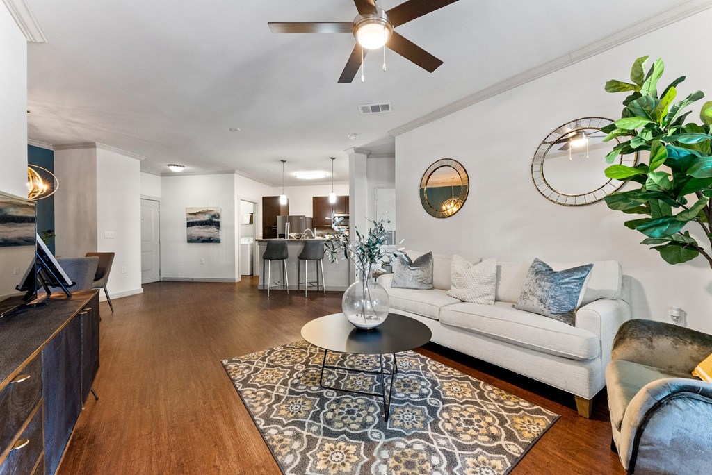 A living room with a white couch and a wooden floor. at Bridge at Indigo, Austin, TX, 78717