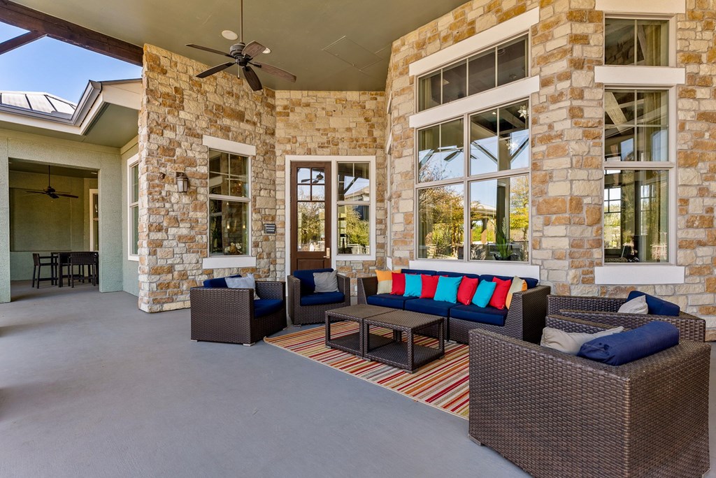 A patio with a couch and chairs. at Bridge at Indigo, Texas, 78717