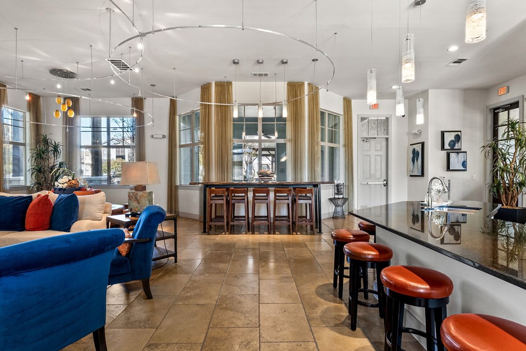A bar area with blue chairs and a counter. at Bridge at Indigo, Austin, Texas