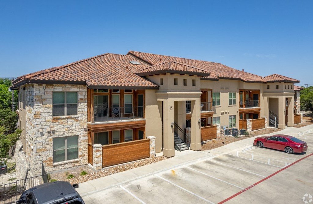 a house with a red car parked in front of it