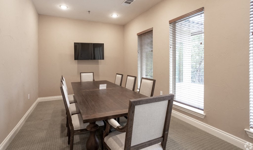 a dining room with a table and chairs and a tv