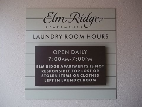 a sign for the laundry room of the inn ridge apartments
