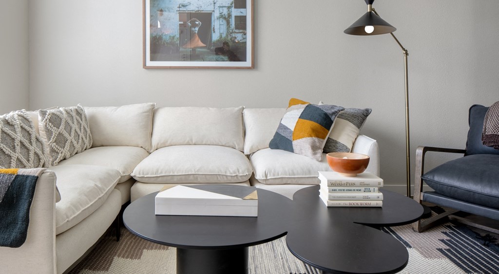 a living room with a white couch and a coffee table