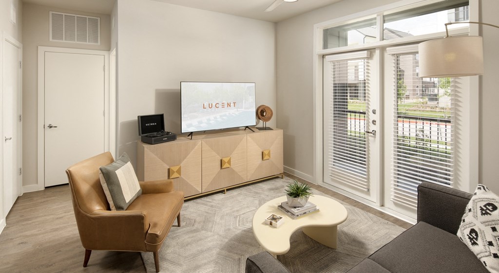 a living room with a couch and a chair and a tv