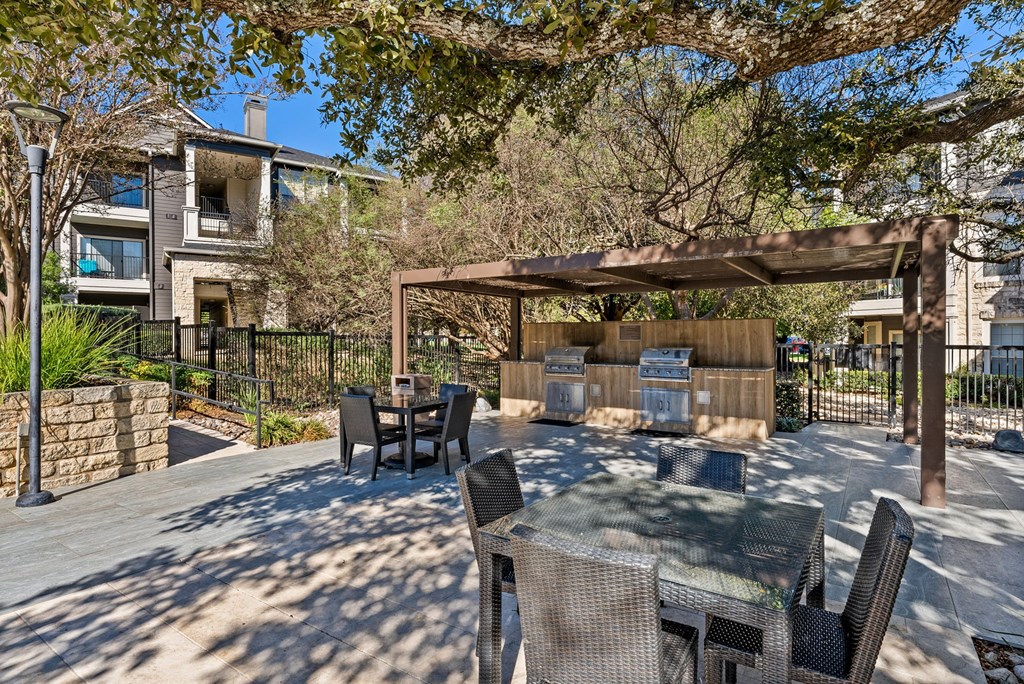 A patio with a table and chairs under a pergola. at Preserve at Rolling Oaks, Texas, 78728