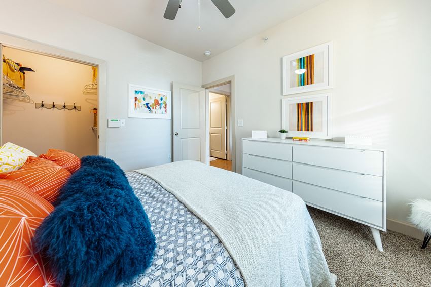a bedroom with a bed and a dresser