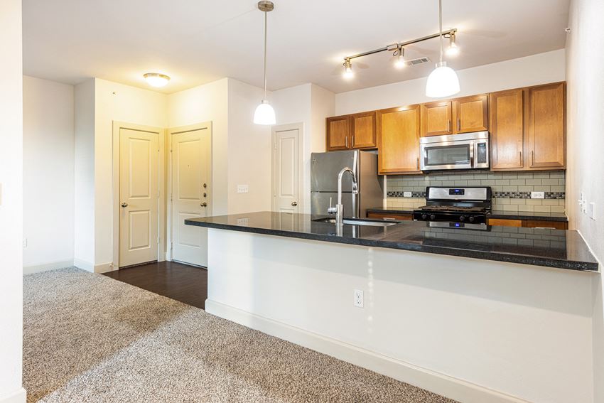 a kitchen with a counter top and a sink and a microwave