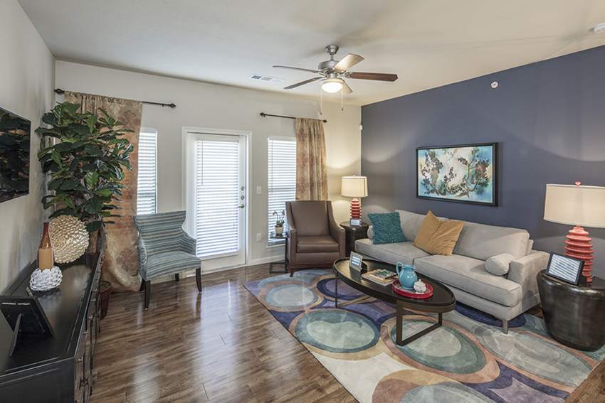 a living room with a couch and a ceiling fan