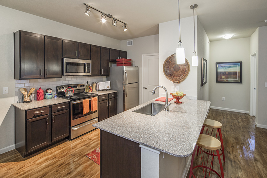 a kitchen with stainless steel appliances and a granite counter top