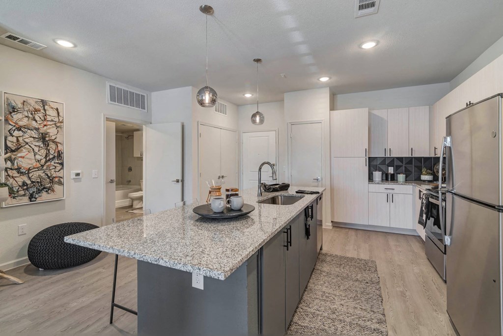 a kitchen with white cabinets and a counter top