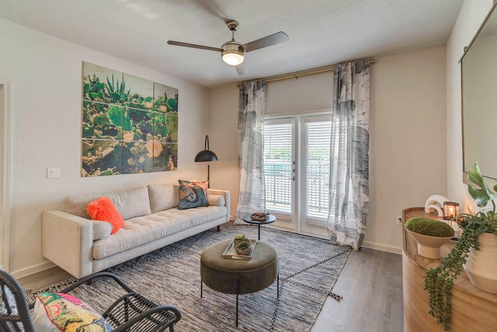 a living room with a couch and a ceiling fan