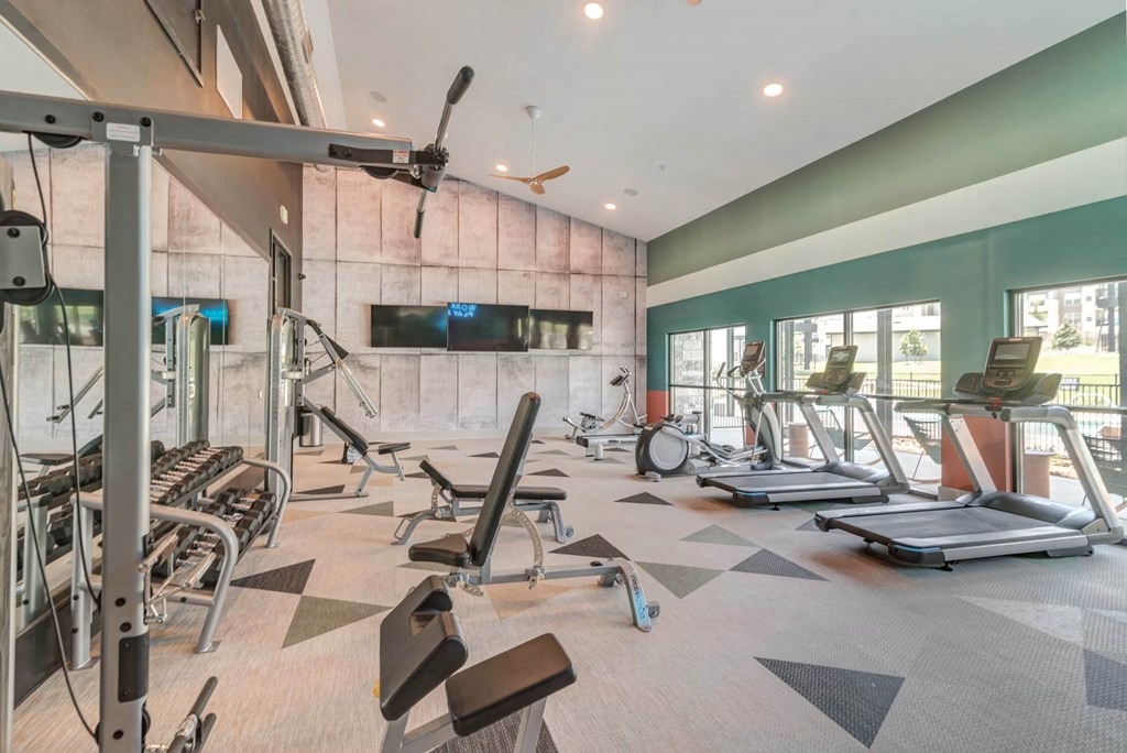 a gym with weights and cardio equipment at the estates apartments