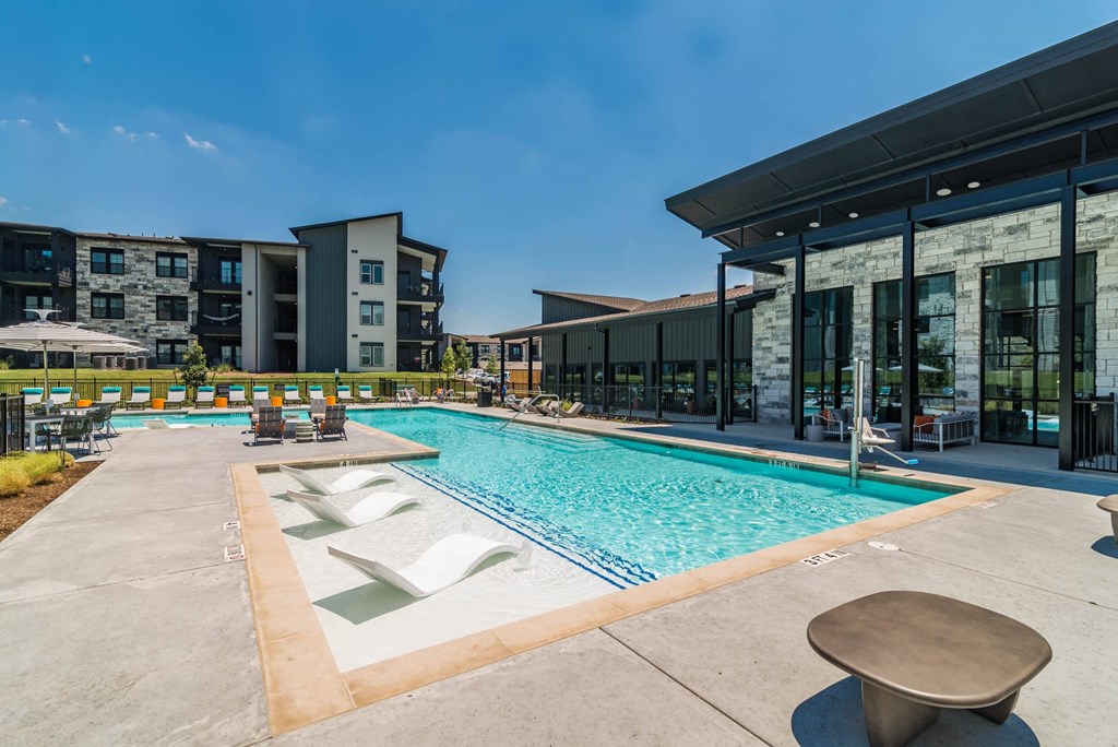a swimming pool with a building in the background