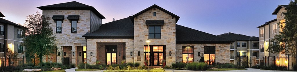 a home is lit up at night in a neighborhood