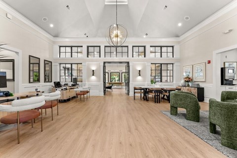 A spacious living room with a long wooden table and chairs.