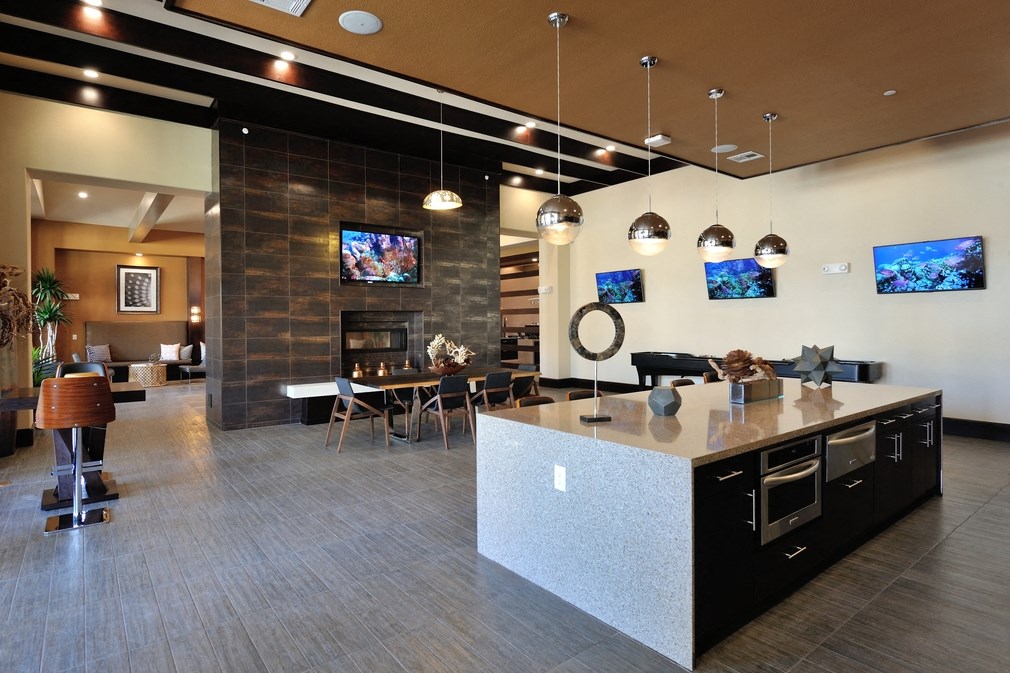 a kitchen with a large island and a living room with a fireplace