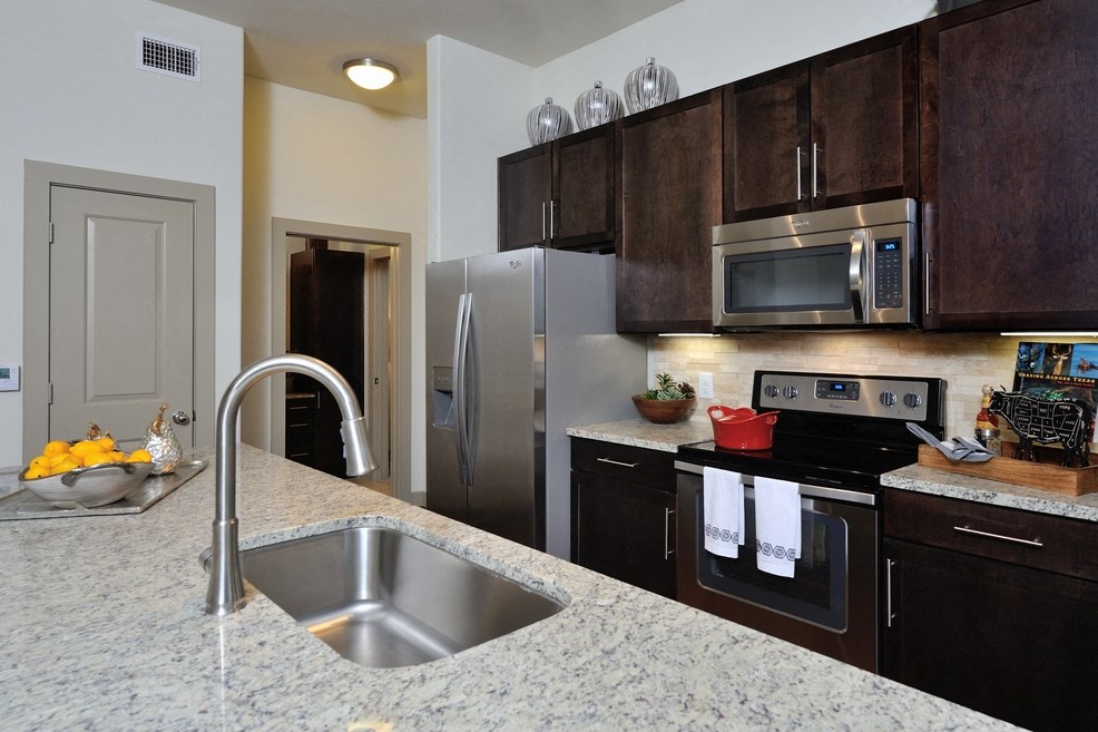 a kitchen with stainless steel appliances and granite counter tops