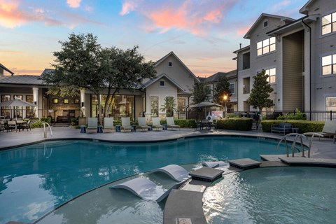 A swimming pool surrounded by a residential area.