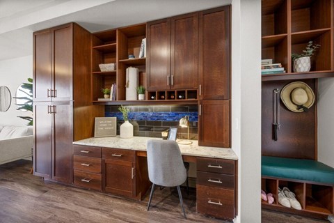 A kitchen with wooden cabinets and a marble countertop.