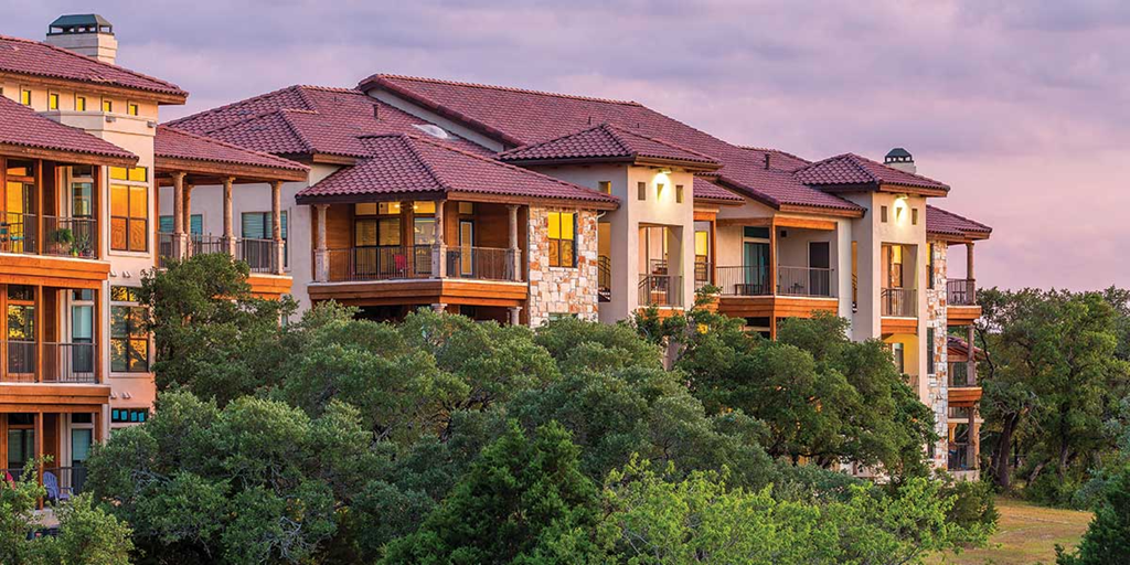 a row of large houses on top of trees
